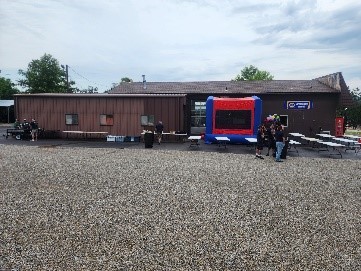 A distant view of the BBQ set up outside the Minute Mechanic building.