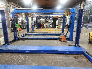 Interior view of the garage showcasing their vehicle jack lifts.